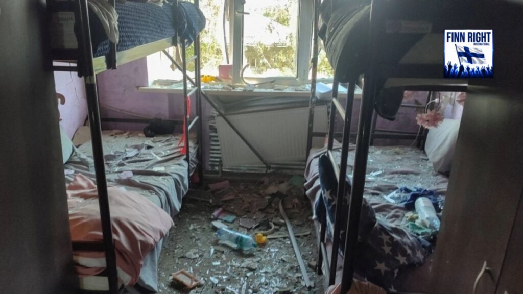 Damaged dormitory in conflict area highlighting civilian harm and human rights concerns.